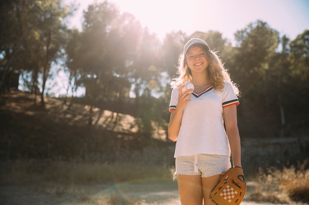 Free photo cheerful young woman with baseball glove