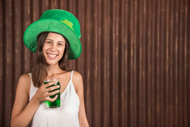 Cheerful young woman with glass of drink