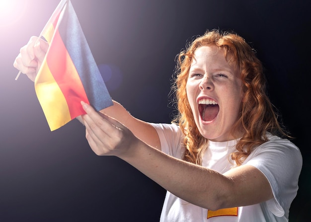 Cheering woman holding german flag