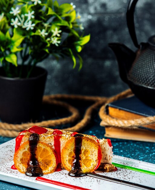 Cheese cake with lemon slice under strawberry syrop