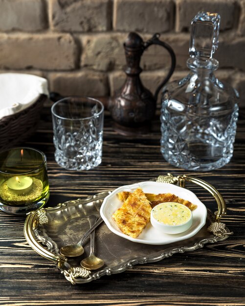 Cheese khachapuri with sauce on the table