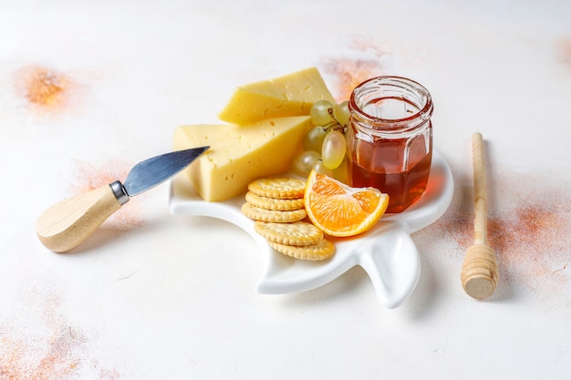 Cheese plate with delicious tilsiter cheese and snacks.