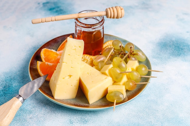 Cheese plate with delicious tilsiter cheese and snacks.