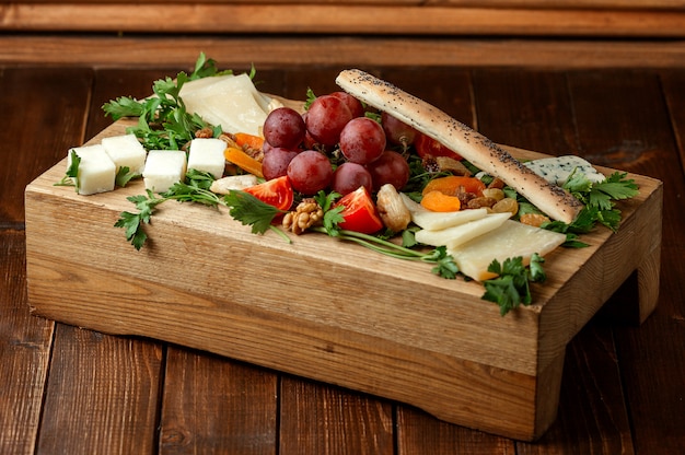 Cheese plate with fruits on the table