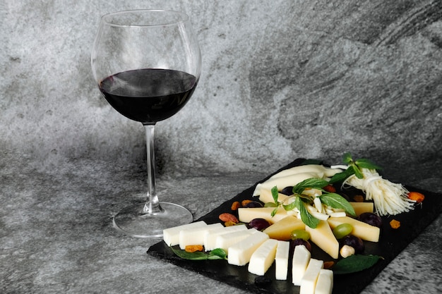 Free Photo cheese plate with glass of wine