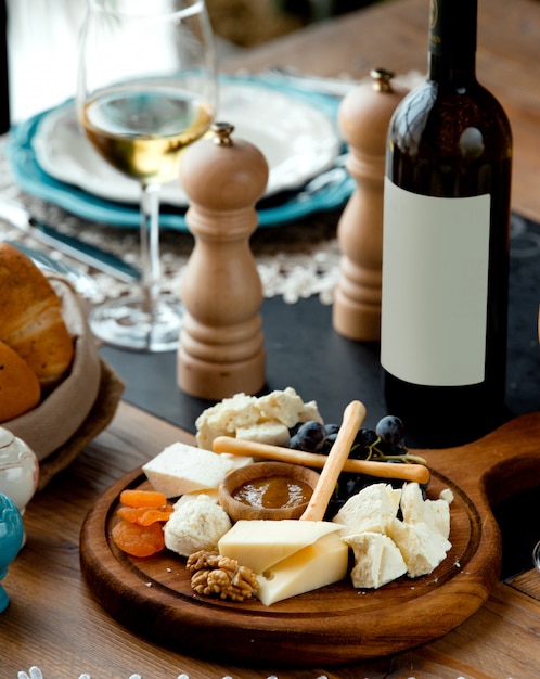 Free Photo cheese set with red wine on wooden board