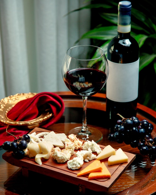 Cheese set with winegrape and glass of wine