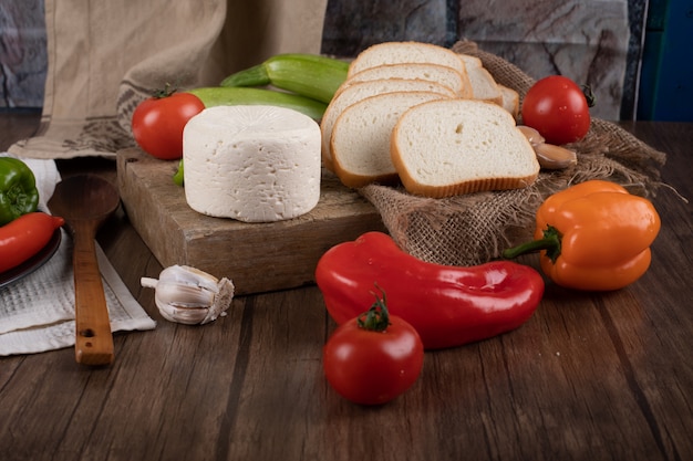 Cheese and vegetables on a wooden table