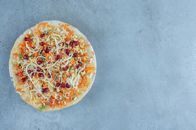 Cheese and walnut salad on a pancake layer on marble surface