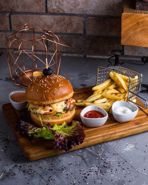 Cheeseburger with french fries on the table