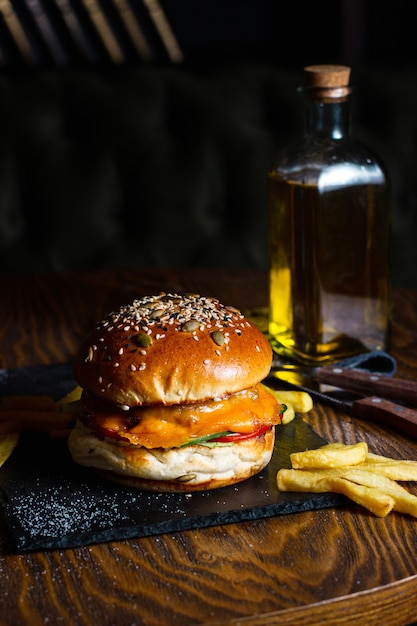 Free photo cheeseburger with french fries on the table