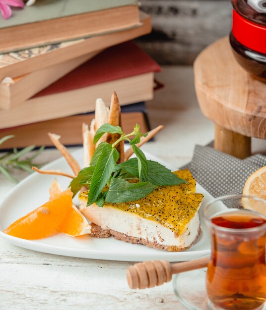 Cheesecake with orange slice on the table