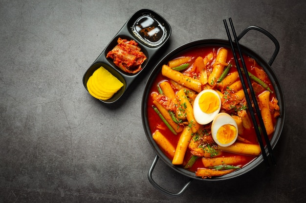 Free photo cheesy tokbokki korean traditional food on black board background. lunch dish.