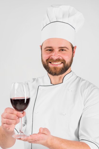 Chef cook smiling and holding glass of wine