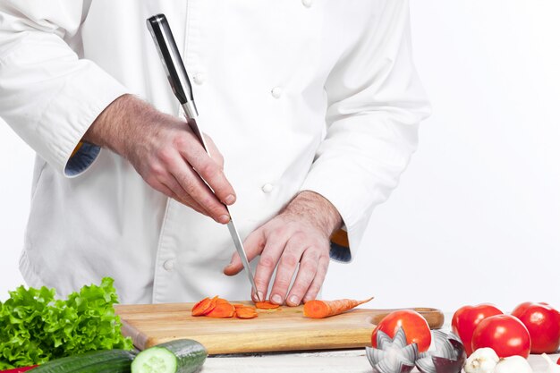 Chef cooking fresh vegetable salad in his kitchen