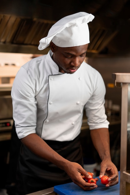 Chef cooking in the kitchen while wearing professional attire