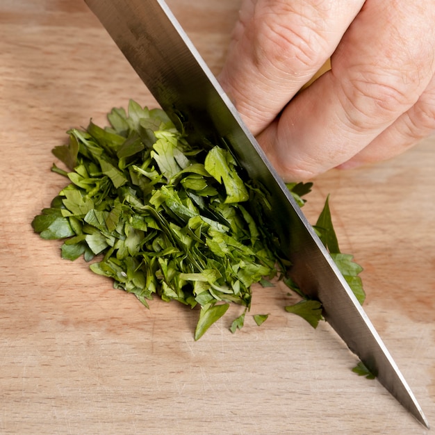 Free photo chef cutting parsley