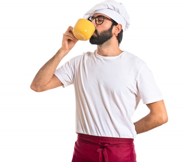 Chef drinking coffee over white background