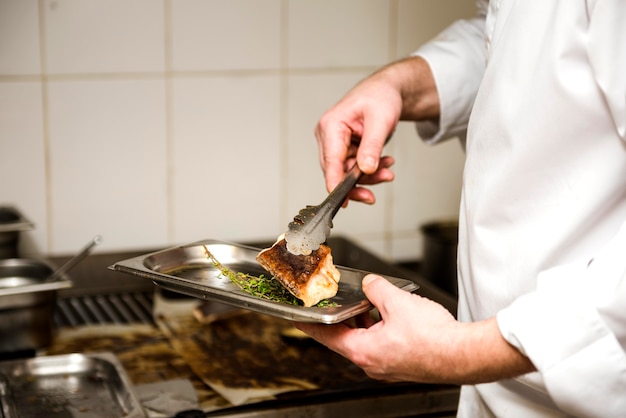 Free photo chef frying fish side view