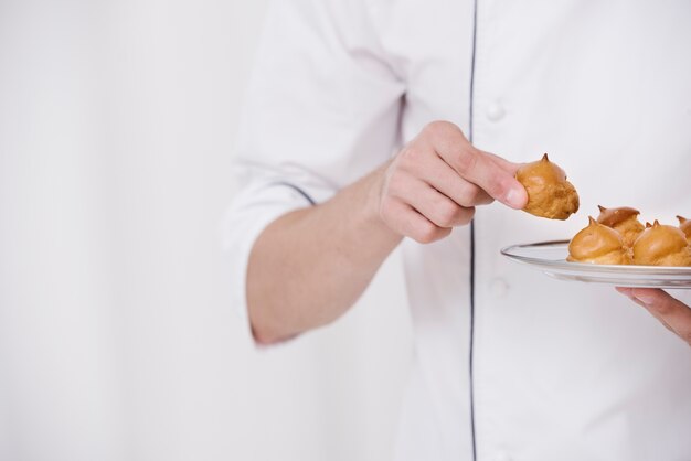 Chef holding plate of meringue