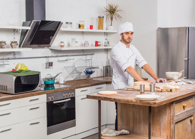 Chef in kitchen making dough