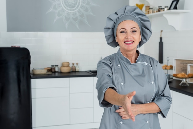 Chef in kitchen prepared to shake hand