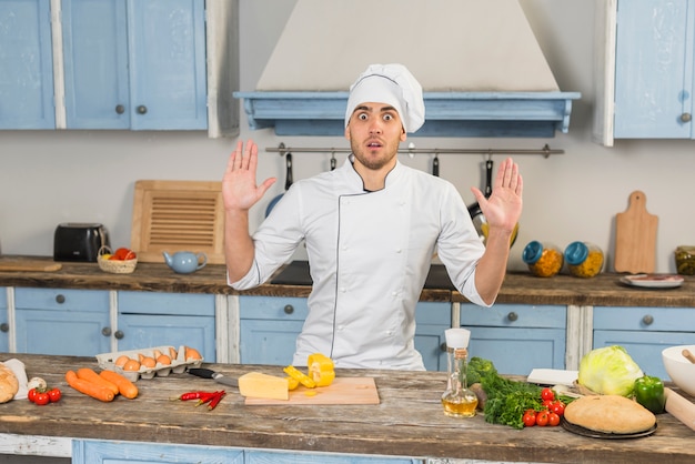 Chef in kitchen with vegetables