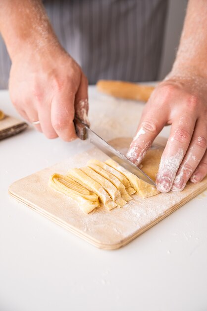 Chef making fresh pasta close-up shot