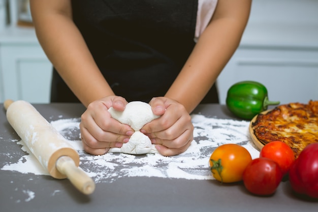 chef making pizza at kitchen