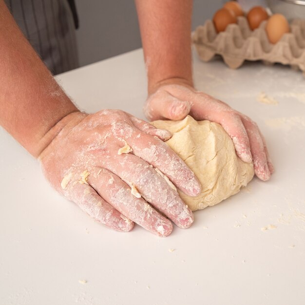 Chef molding dough with eggs