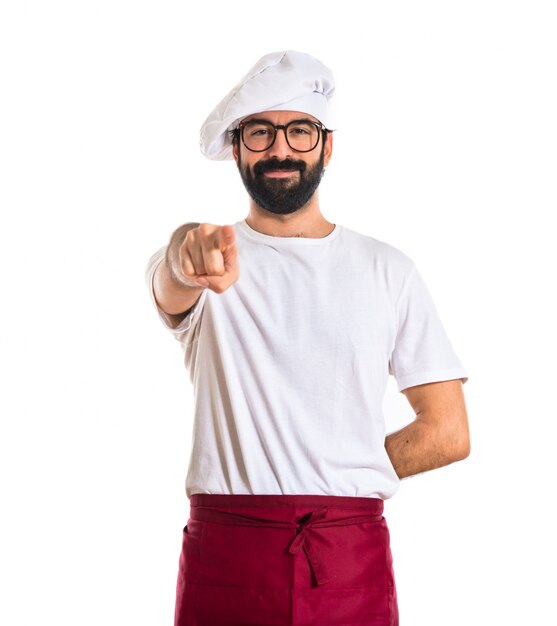 Chef pointing to the front over white background