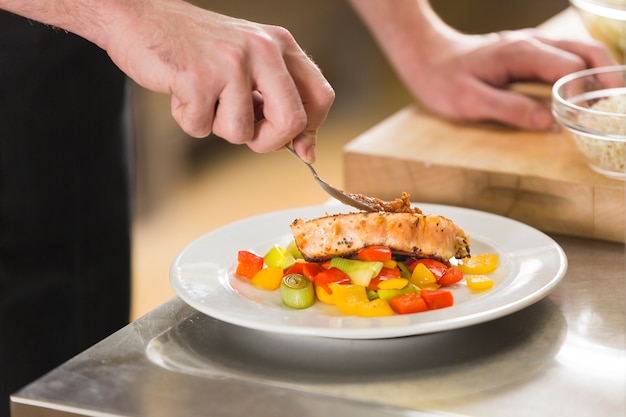 Free photo chef preparing a dish of healthy food