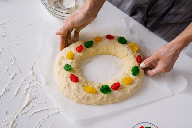 Chef preparing epiphany day dessert with colorful candy