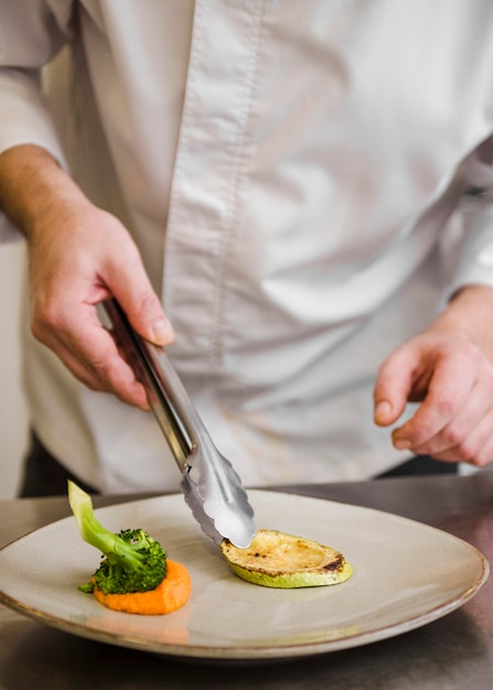 Chef preparing fried zucchini front view