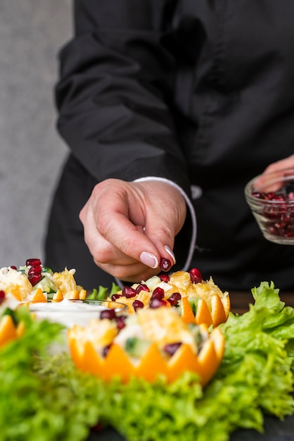 Free photo chef preparing fruit dish