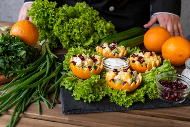 Free photo chef presenting dish with salad