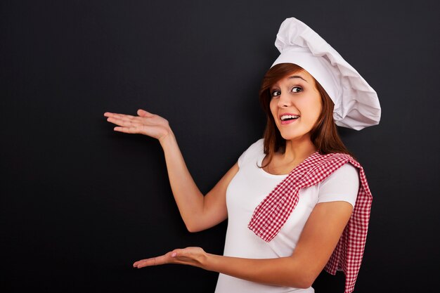 Chef showing blank menu on blackboard