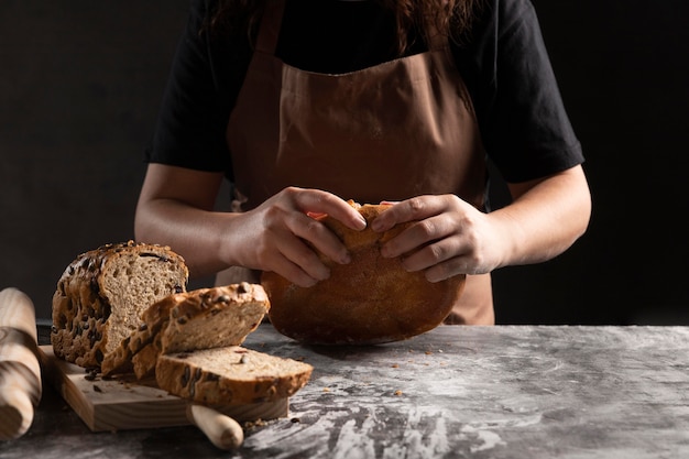 Chef tearing baked bread apart