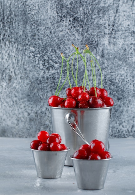 Free Photo cherries in buckets, side view.