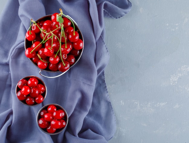 Free photo cherries in buckets, top view.