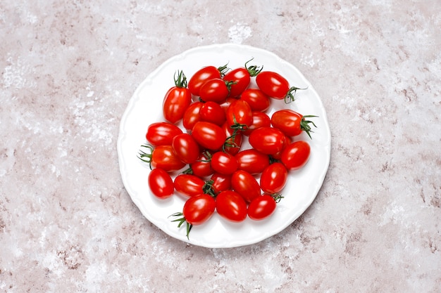 Cherry tomatoes of various colors,yellow and red cherry tomatoes on light background