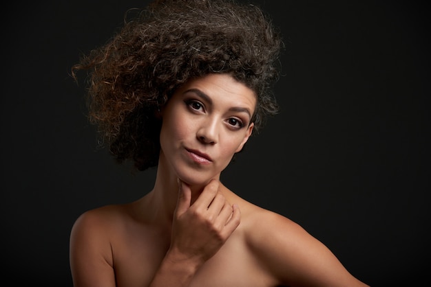 Chestup portrait of a curly brunette 