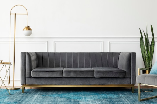 Chic mid-century modern luxury aesthetics living room with gray velvet couch and blue rug