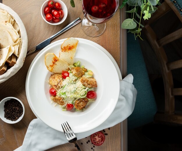 Chicken caesar salad with crutones and vegetables