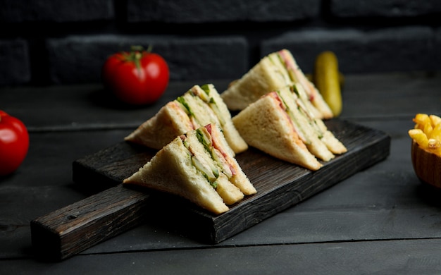 Free photo chicken club sandwich on a wooden board