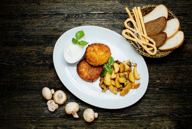 Chicken cutlets with fried potatoes and mushrooms