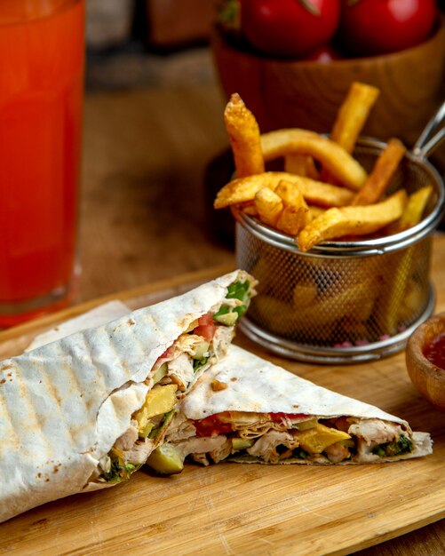 Chicken doner wrap in flatbread served with french fries