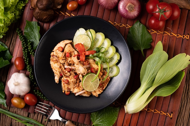 Chicken Larb on the plate With dried chilies, tomatoes, spring onions and lettuce