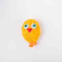 Free photo chicken made of yellow wool yarn ball