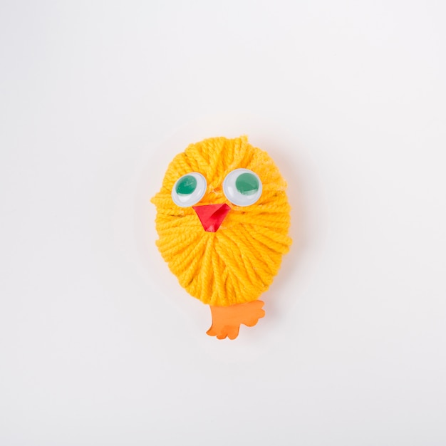 Free Photo chicken made of yellow wool yarn ball